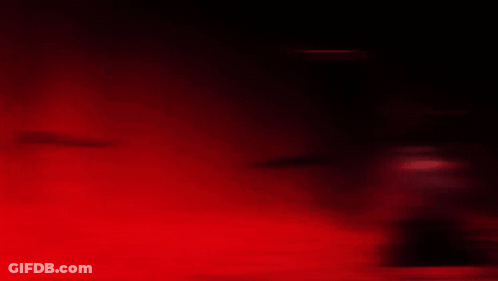 A Man With Many Eyes Is Holding A Sword In His Right Hand GIF