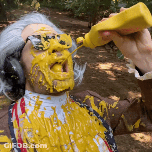 A Man With Mustard On His Face And A Bottle Of Mustard In His Hand GIF