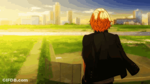 A Man With Orange Hair Is Standing In A Field GIF