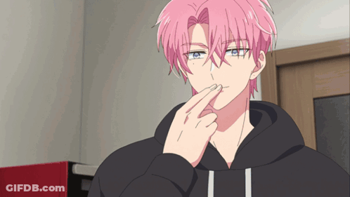 A Man With Pink Hair And Blue Eyes Is Holding His Finger To His Mouth GIF