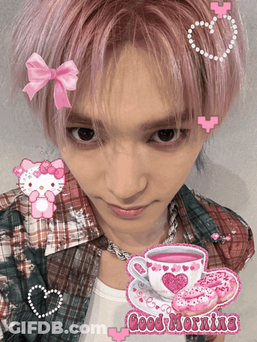 A Man With Pink Hair Has A Hello Kitty Sticker On His Head And A Cup Of Tea GIF