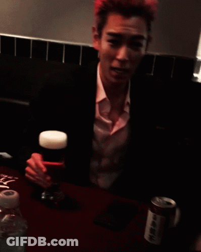A Man With Pink Hair Holds A Glass Of Beer In His Hand GIF