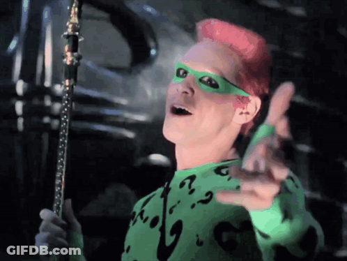 A Man With Pink Hair Is Wearing A Green Sweater With A Question Mark On The Front GIF