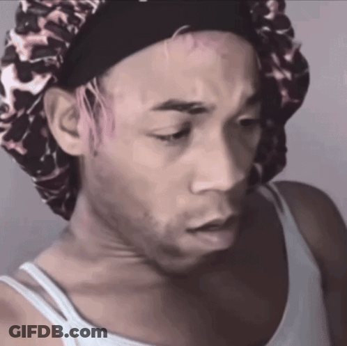 A Man With Pink Hair Is Wearing A Leopard Print Bonnet GIF