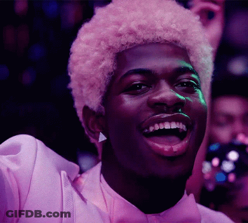 A Man With Pink Hair Is Wearing A Purple Shirt And Bow Tie GIF