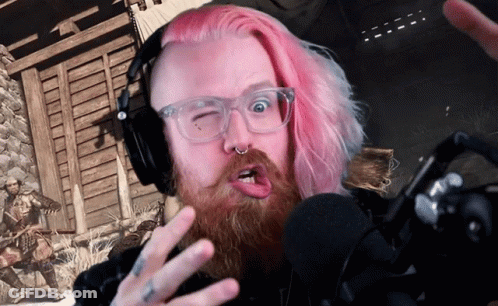 A Man With Pink Hair Is Wearing Headphones And Making A Face GIF