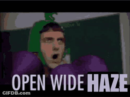 A Man With Purple Boxing Gloves And The Words Open Wide Haze Below Him GIF