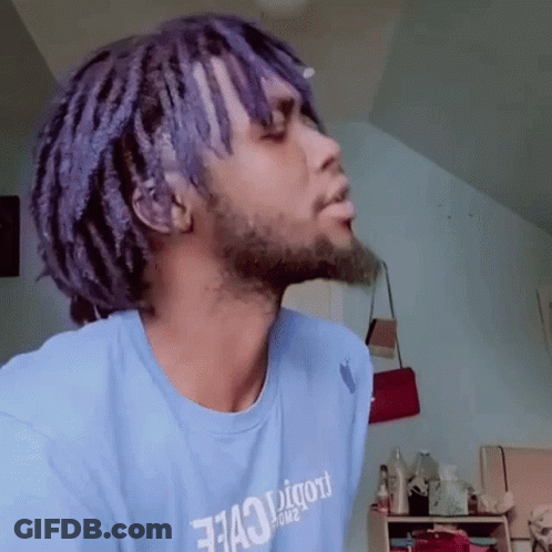 A Man With Purple Hair And A Beard Is Wearing A Blue Shirt That Says " 7143 " On It GIF