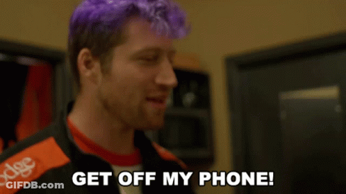 A Man With Purple Hair And A Jacket That Says Dodge On It GIF