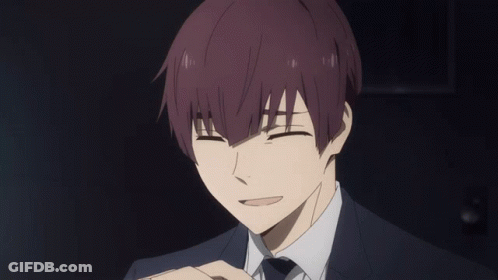 A Man With Purple Hair And A Suit Is Smiling With His Eyes Closed GIF