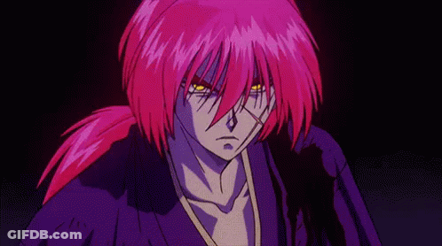 A Man With Purple Hair And Yellow Eyes Is Standing In The Dark . GIF