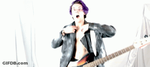 A Man With Purple Hair Is Holding A Guitar GIF