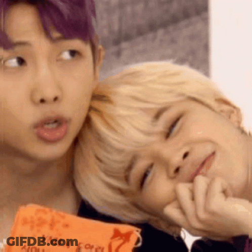 A Man With Purple Hair Is Putting His Head On Another Man 'S Head . GIF