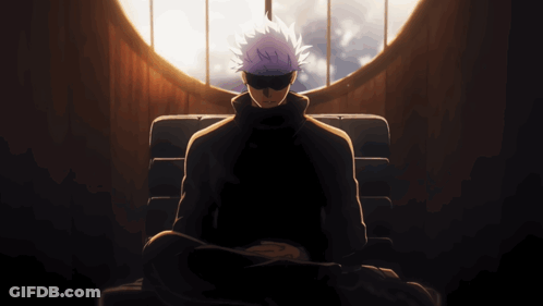 A Man With Purple Hair Is Sitting In Front Of A Large Window GIF