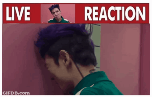 A Man With Purple Hair Is Standing In Front Of A Live Reaction Sign GIF