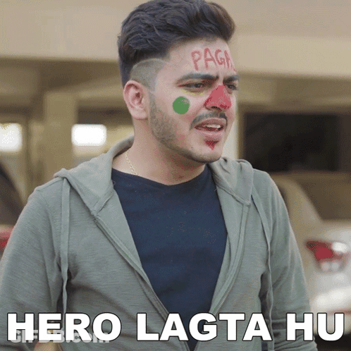 A Man With Red And Green Paint On His Face Has The Words Hero Lagta Hu Written Below Him GIF