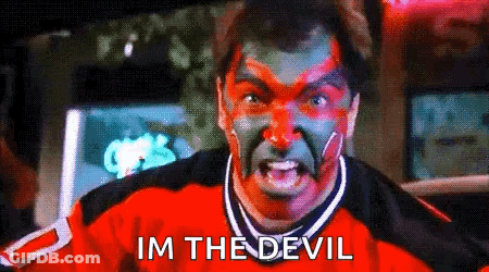 A Man With Red And Green Paint On His Face Has The Words Im The Devil Above Him GIF