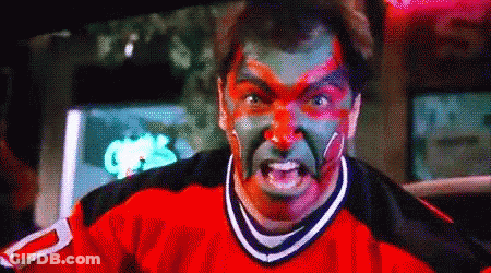 A Man With Red And Green Paint On His Face Is Wearing A Jersey With The Number 2 On It . GIF
