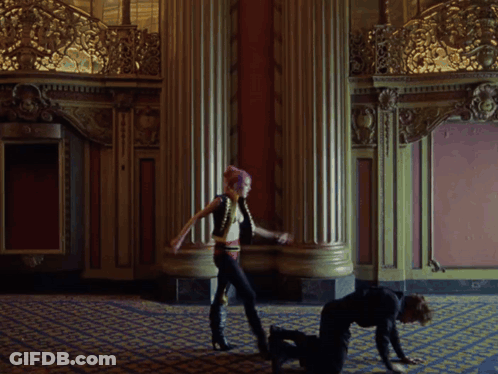 A Man With Red Curly Hair Is Looking At Something GIF