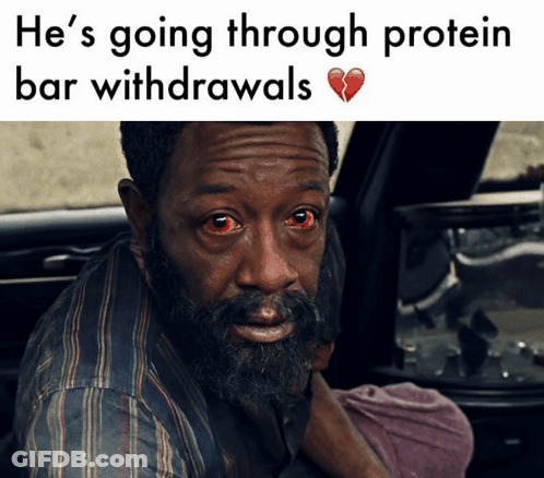 A Man With Red Eyes Is Sitting In The Back Seat Of A Car With A Broken Heart Behind Him GIF