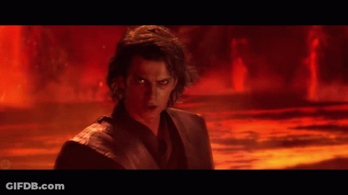 A Man With Red Eyes Is Standing In A Dark Room GIF
