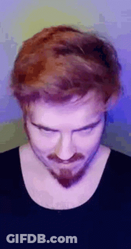 A Man With Red Hair And A Beard Is Making A Funny Face With His Eyes Closed . GIF
