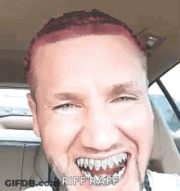 A Man With Red Hair And A Beard Is Sitting In A Car With His Mouth Open . GIF