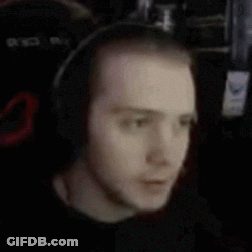 A Man With Red Hair And Headphones On His Neck GIF