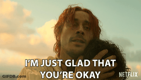 A Man With Red Hair Is Hugging Another Man With The Words I 'M Just Glad That You 'Re Okay Below Him GIF