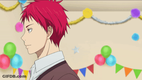 A Man With Red Hair Is Smiling In Front Of Balloons And Flags GIF