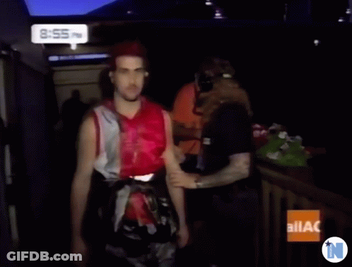 A Man With Red Hair Is Standing In Front Of A Sign That Says Ilac On It GIF