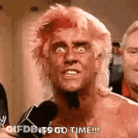 A Man With Red Hair Is Talking Into A Microphone And Making A Funny Face . GIF