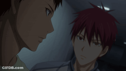 A Man With Red Hair Is Talking To Another Man In A Dark Room GIF