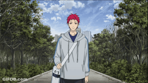 A Man With Red Hair Is Walking Down A Path In A Park GIF