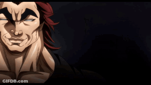 A Man With Red Hair Is Waving His Hand In A Dark Room GIF