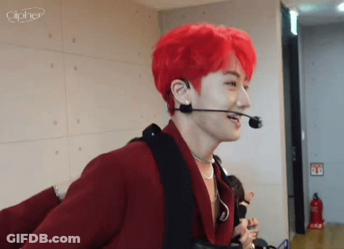 A Man With Red Hair Is Wearing A Microphone And Earphones . GIF