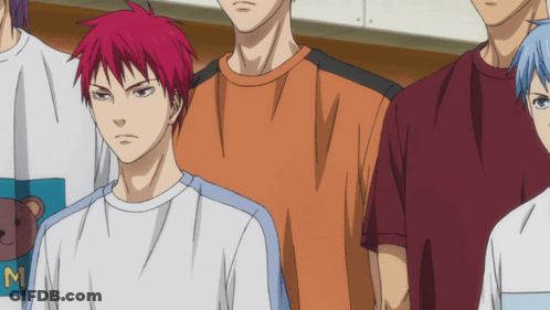 A Man With Red Hair Is Wearing A White Shirt With The Letter M On It GIF