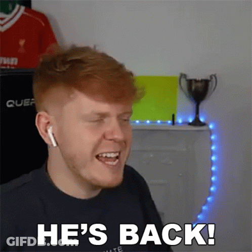 A Man With Red Hair Is Wearing Headphones And Says He 'S Back GIF
