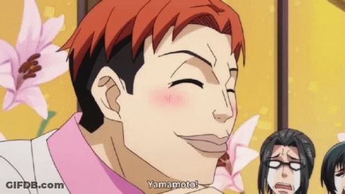 A Man With Red Hair Says Yamamoto In Front Of Some Flowers GIF