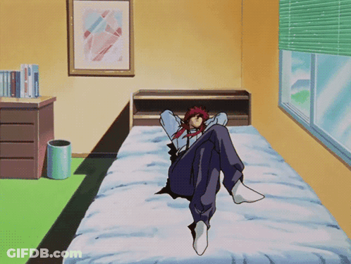A Man With Red Hair Sits On A Bed In A Bedroom GIF