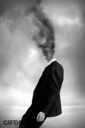 A Man With Smoke Coming Out Of His Head In A Black And White Photo GIF