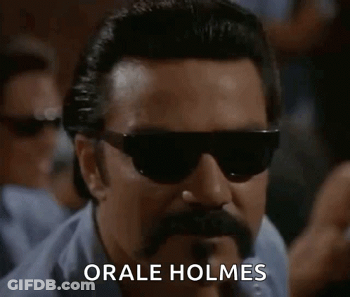 A Man With Sunglasses And A Mustache Says " Orale Holmes " GIF