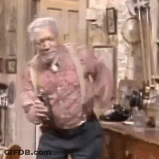 A Man With Suspenders Is Dancing In A Room . GIF