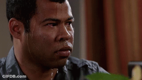 A Man With Sweat Coming Out Of His Face Is Looking At Something . GIF