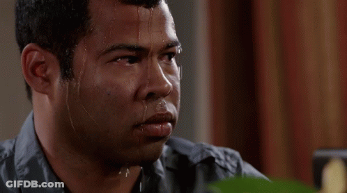 A Man With Sweat Coming Out Of His Face Is Looking At The Camera . GIF