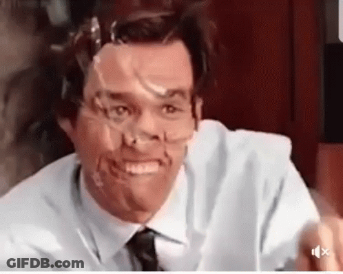 A Man With Tape On His Face Is Smiling . GIF
