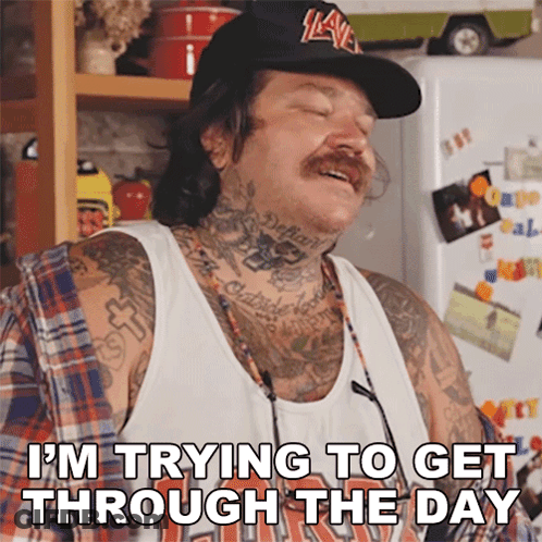 A Man With Tattoos And A Hat Is Saying " I 'M Trying To Get Through The Day " GIF