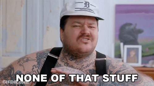 A Man With Tattoos And A Hat That Says None Of That Stuff GIF