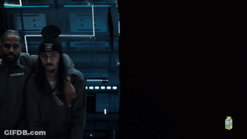 A Man With The Name Black On His Shirt Is Being Held GIF
