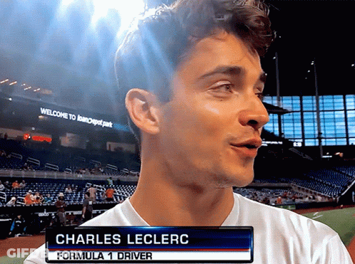 A Man With The Name Charles Leclerc On A Sign GIF